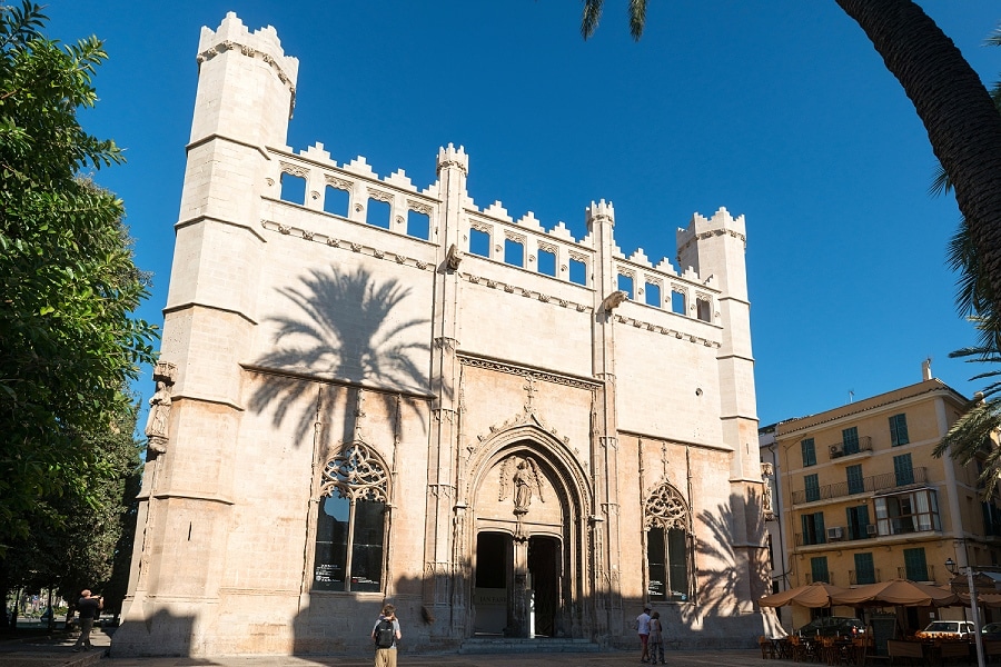 LRent a car and visit Palma. La Lonja in Palma is the historic former stock exchange, situated right next to the port. Built in Gothic style between 1450 and 1452, the building features elegant, palm-like columns. Visitors can enjoy stunning city views from the windowsills.